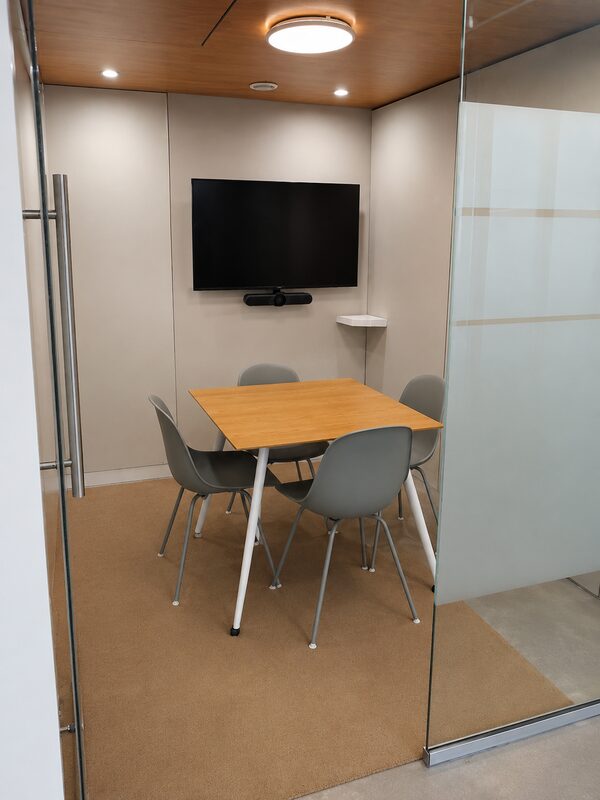 Tide Room meeting room behind its glass door at Lyall Bay WorkHub