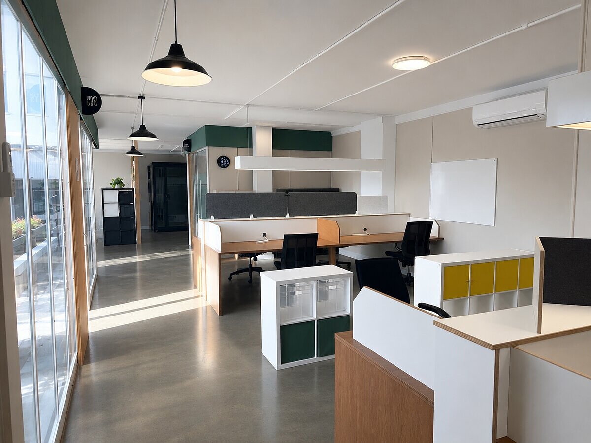 Open plan coworking space overview at Lyall Bay WorkHub Wellington